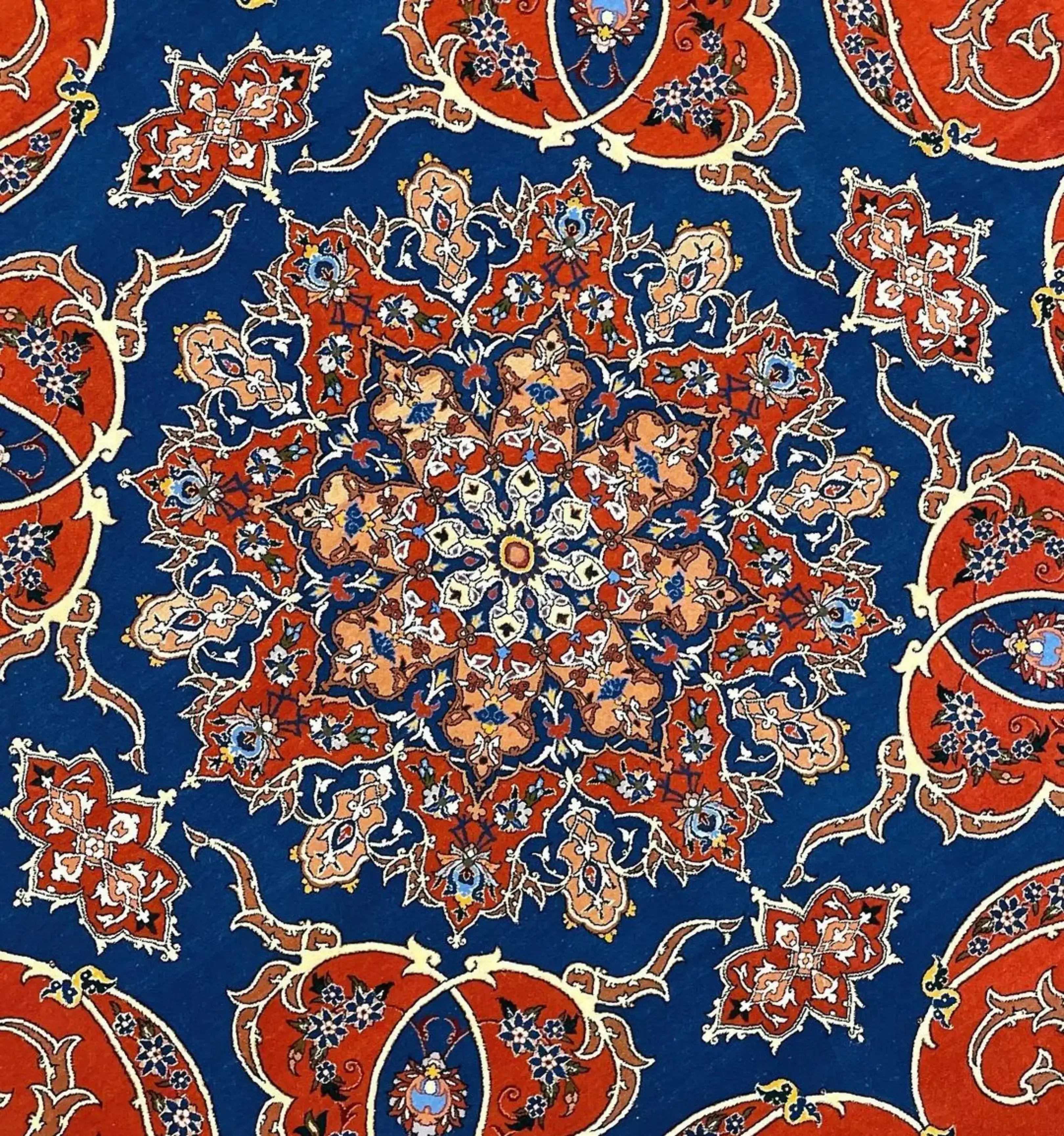 Persian circular rug with intricate floral patterns and a luxurious blend of wool and silk.
